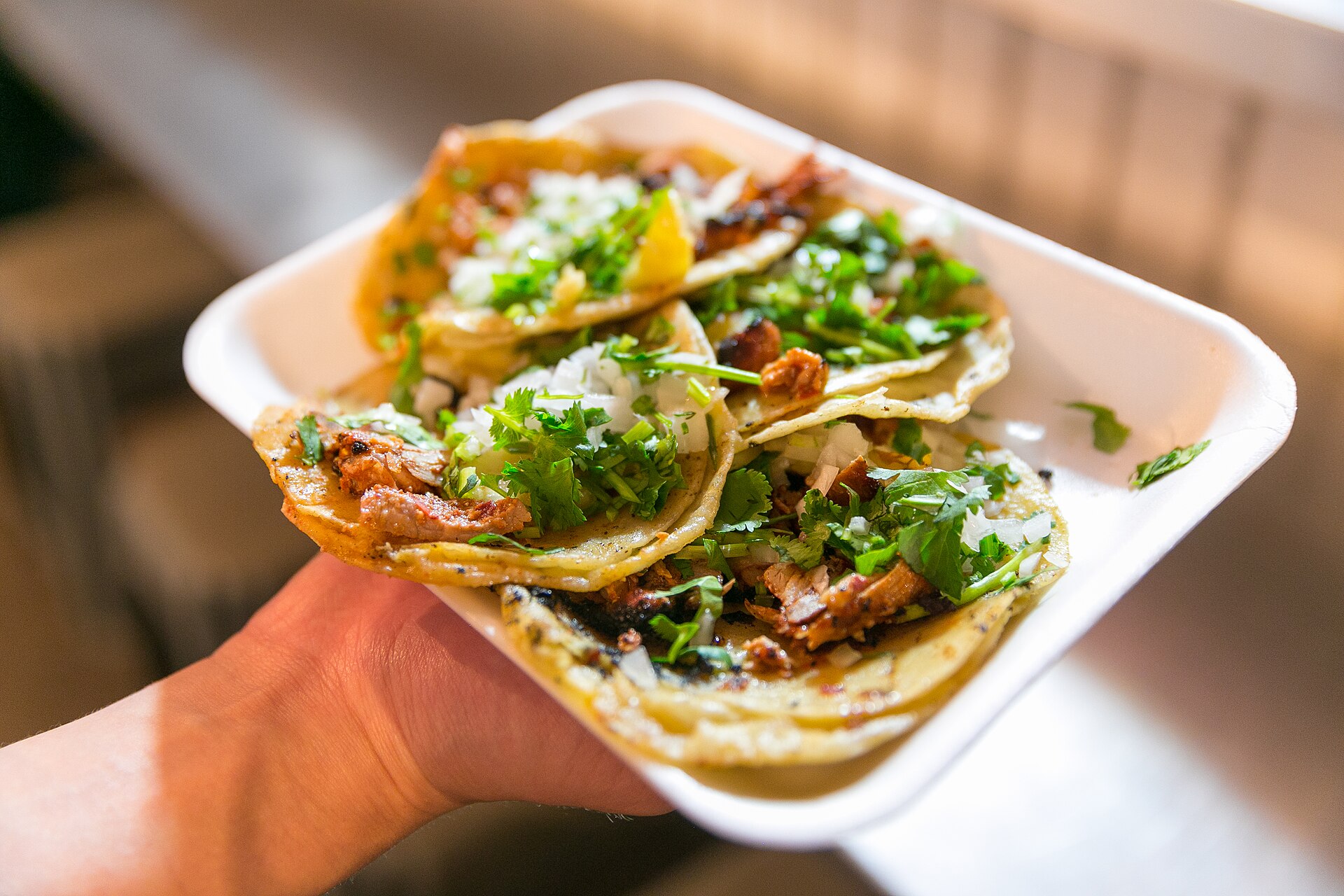 Al pastor tacos topped with pineapple, onion and cilantro